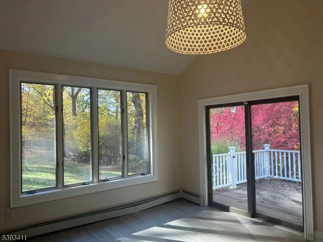 a view of porch with a floor to ceiling window and wooden floor