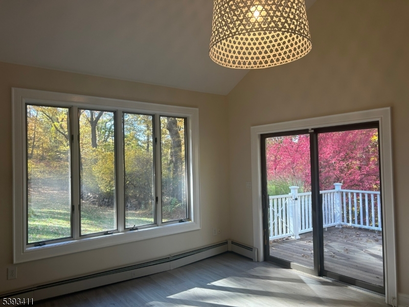 102 Drakestown Road Hackettstown, NJ 07840 - Photo 6 of 28 a view of porch with a floor to ceiling window and wooden floor