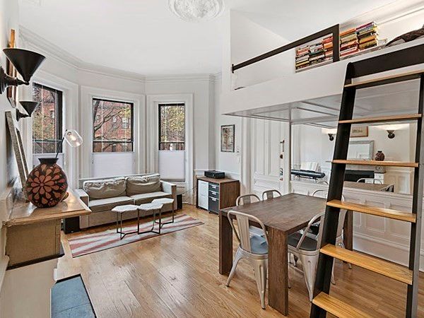 a living room with furniture a rug and a window
