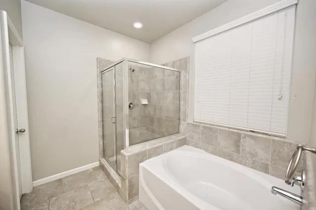 a bathroom with a bathtub and a shower