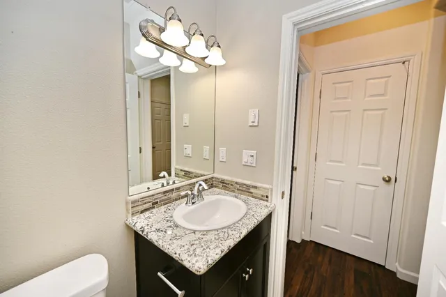 a bathroom with a sink vanity and a mirror