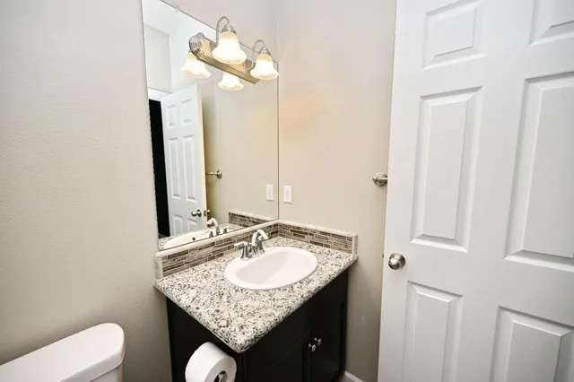 a bathroom with a sink vanity and a mirror