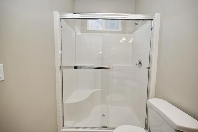 a bathroom with a shower and a toilet