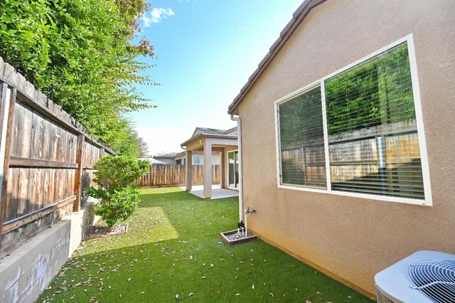 a view of an house with backyard space and balcony