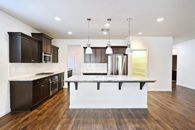 a large kitchen with stainless steel appliances kitchen island a large island in the center