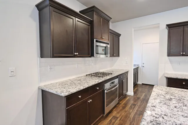 a kitchen with a stove and a microwave