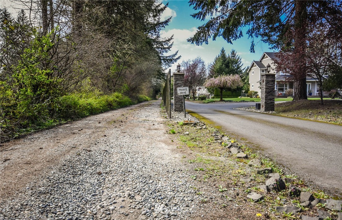 5425 Blvd Ext Road Southeast Olympia, WA 98501 - Photo 2 of 29 a road view with large trees