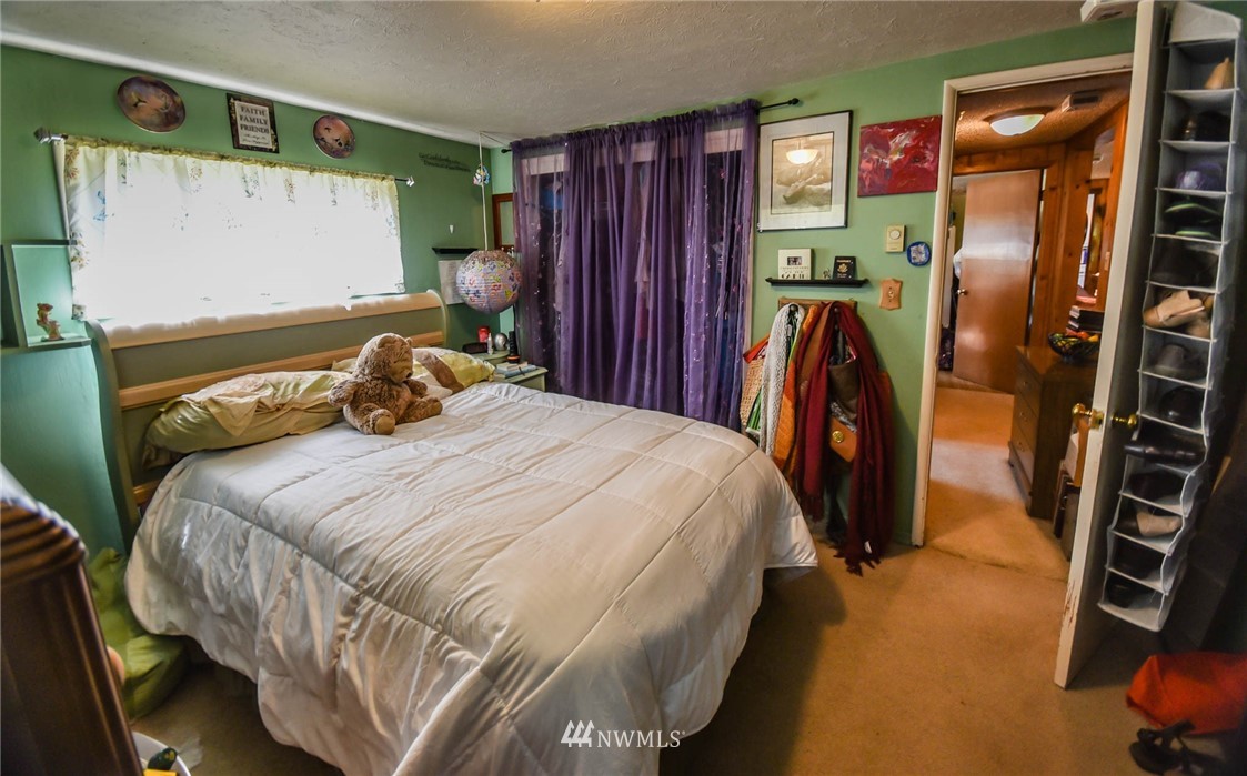 5425 Blvd Ext Road Southeast Olympia, WA 98501 - Photo 25 of 29 a bedroom with a bed next to a window