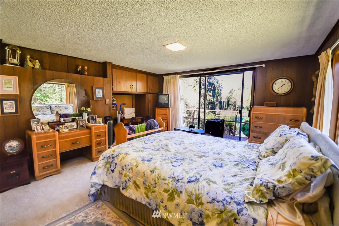 5425 Blvd Ext Road Southeast Olympia, WA 98501 - Photo 27 of 29 a bedroom with a bed dresser and a large window