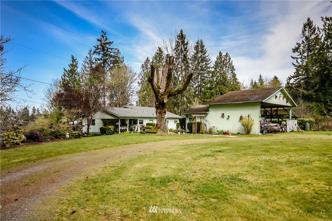 5425 Blvd Ext Road Southeast Olympia, WA 98501 - Photo 4 of 29 a front view of a house with a garden and trees