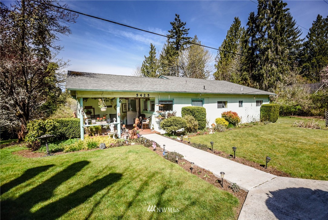 5425 Blvd Ext Road Southeast Olympia, WA 98501 - Photo 8 of 29 a view of a house with backyard sitting area and garden