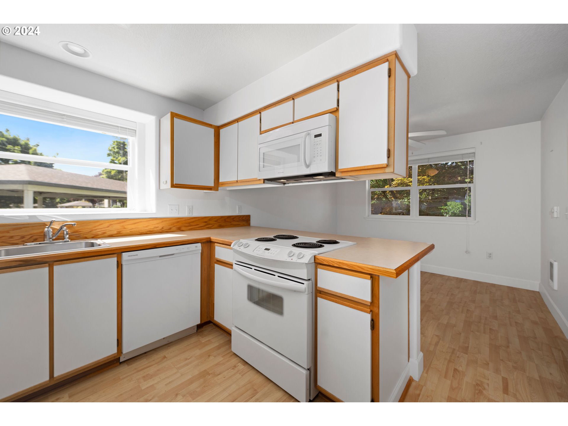 4744 West Powell Boulevard, Unit 127 Gresham, OR 97030 - Photo 12 of 37 a kitchen with stainless steel appliances granite countertop a stove a sink and a microwave