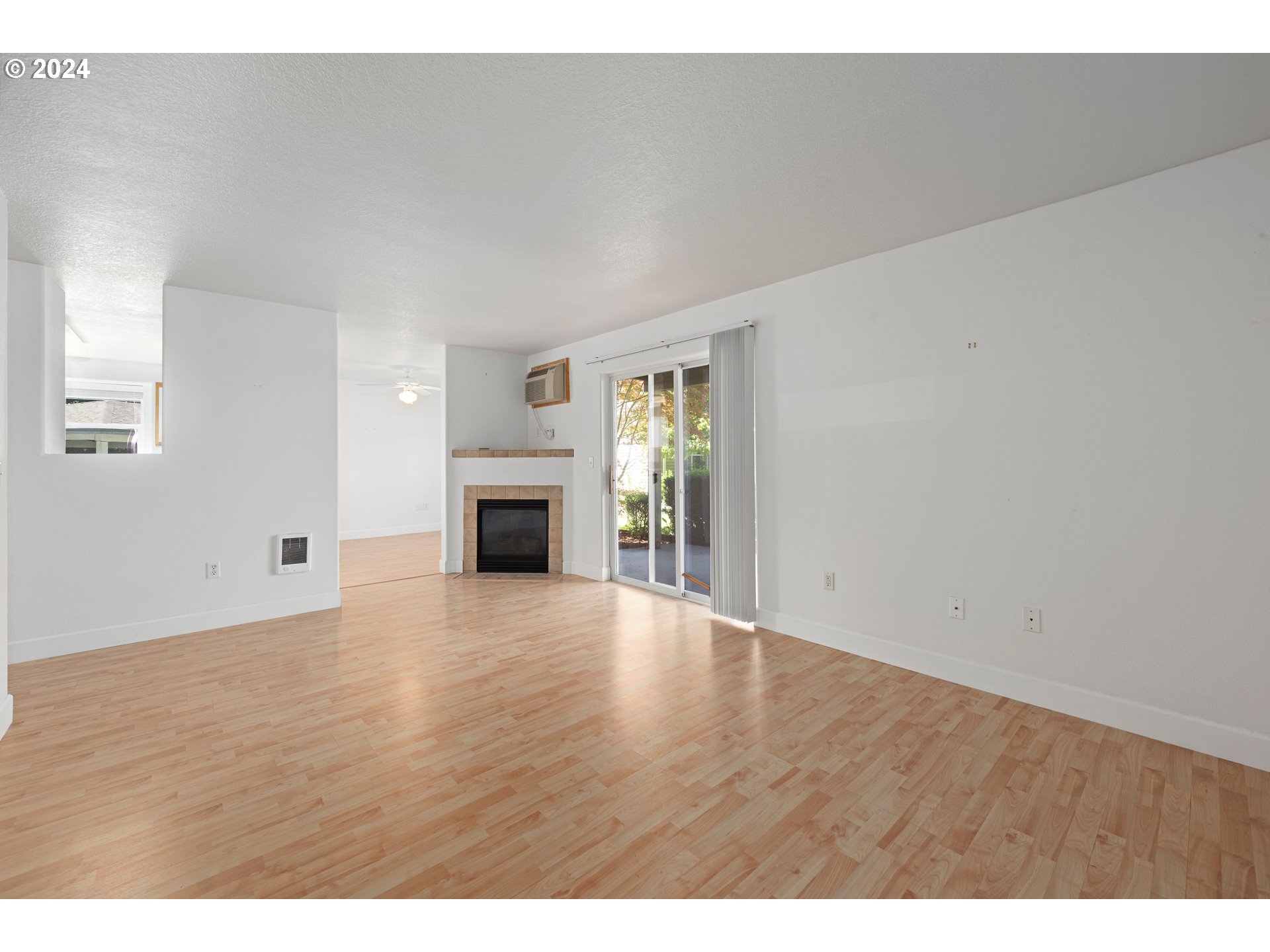 4744 West Powell Boulevard, Unit 127 Gresham, OR 97030 - Photo 15 of 37 a view of empty room with wooden floor and fireplace
