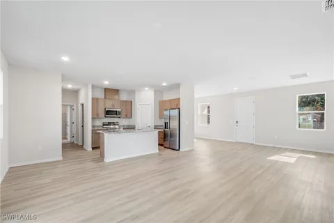 a view of a kitchen with a sink and a refrigerator
