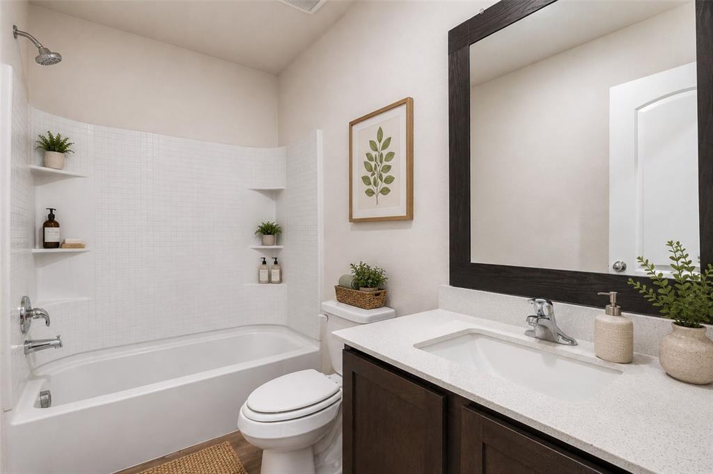 144 Barbwire Way Newark, TX 76071 - Photo 21 of 32 a bathroom with a sink a toilet and a bathtub