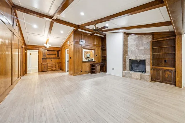a view of empty room with a fireplace and cabinet