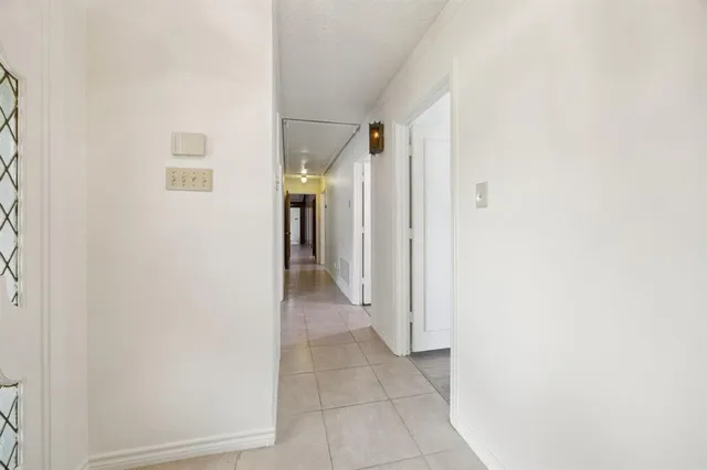 a view of a hallway with a white refrigerator