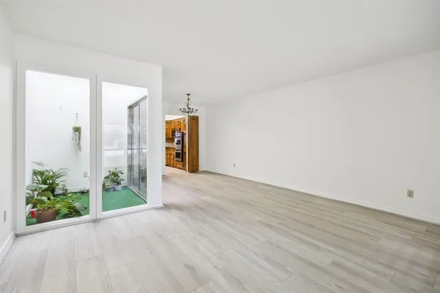 a view of a room with wooden floor