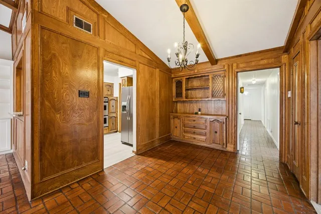 a view of a hallway with wooden shelves