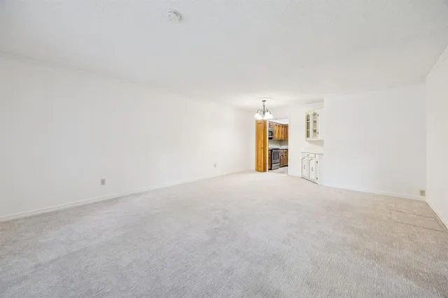 a view of an empty room with a fireplace