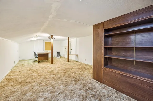 a view of an empty room with a fireplace