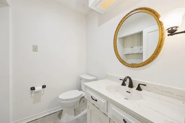 a bathroom with a sink a mirror and a toilet