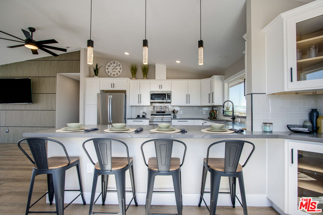 60777 Adele Road Landers, CA 92285 - Photo 12 of 43 a kitchen with granite countertop white cabinets and stainless steel appliances