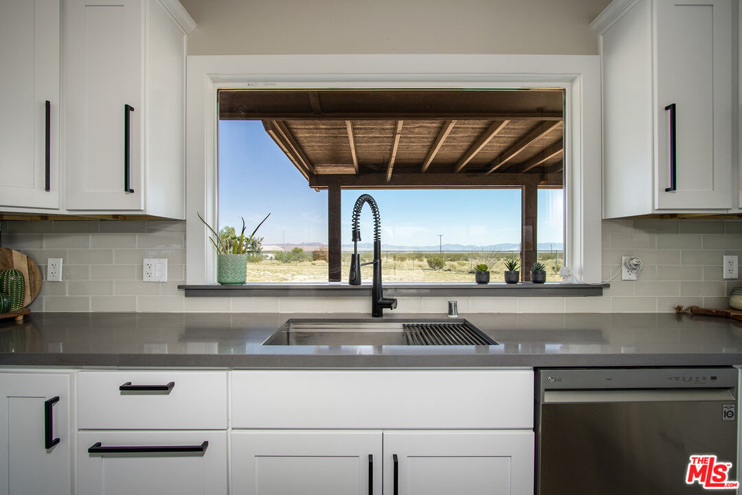 60777 Adele Road Landers, CA 92285 - Photo 14 of 43 a kitchen with a sink and cabinets