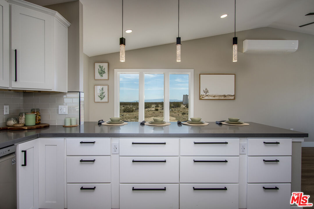 60777 Adele Road Landers, CA 92285 - Photo 15 of 43 a kitchen with stainless steel appliances white cabinets and a sink