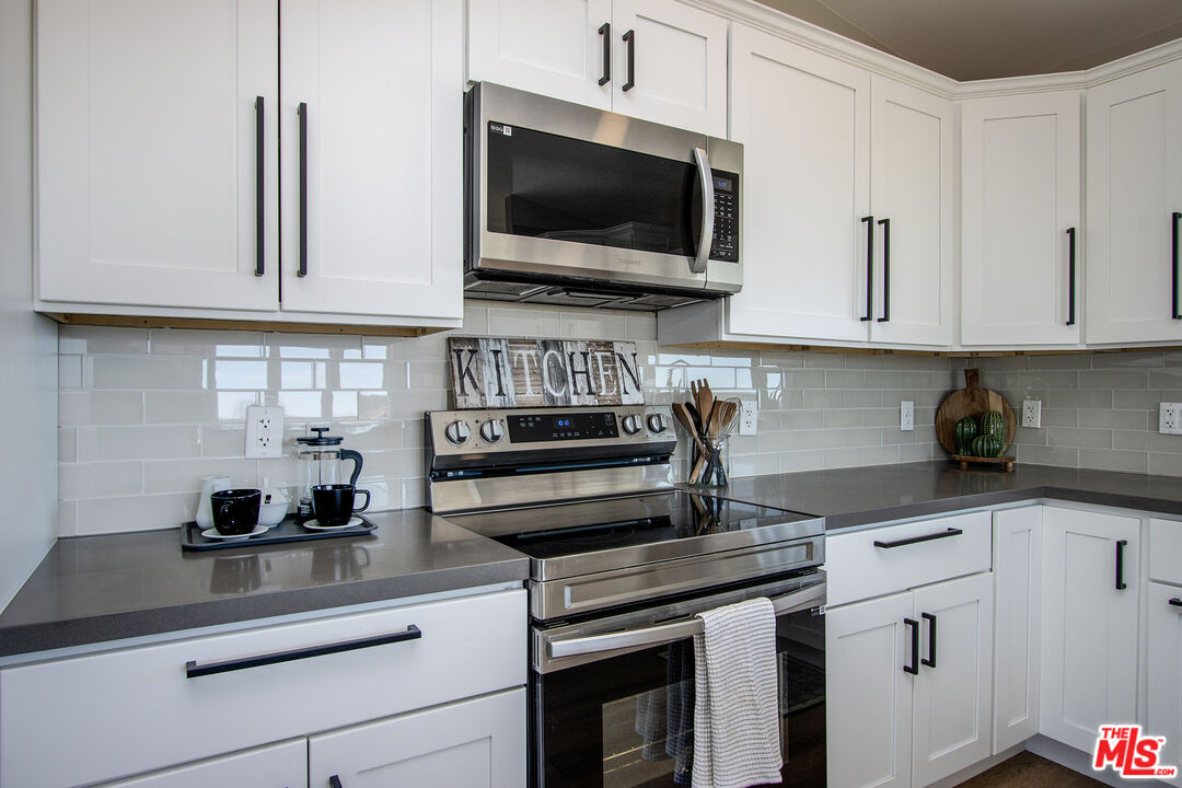 60777 Adele Road Landers, CA 92285 - Photo 16 of 43 a kitchen with cabinets appliances and a sink