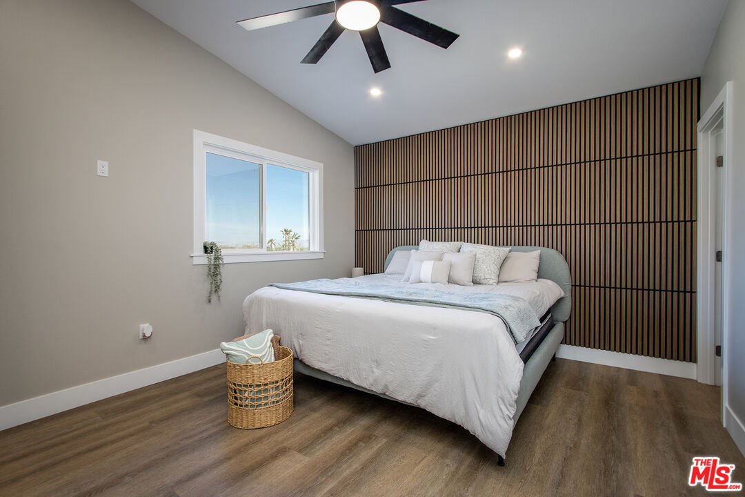 60777 Adele Road Landers, CA 92285 - Photo 17 of 43 a bedroom with a bed and a chandelier