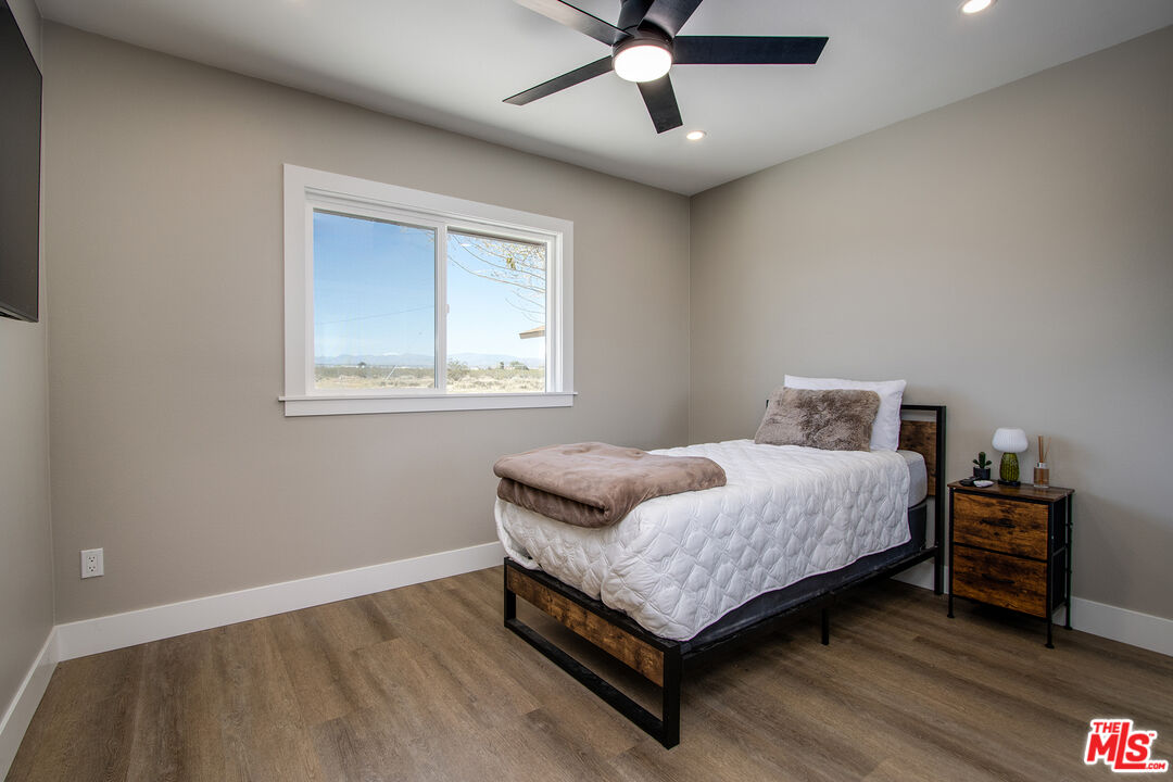 60777 Adele Road Landers, CA 92285 - Photo 20 of 43 a bedroom with a bed and wooden floor