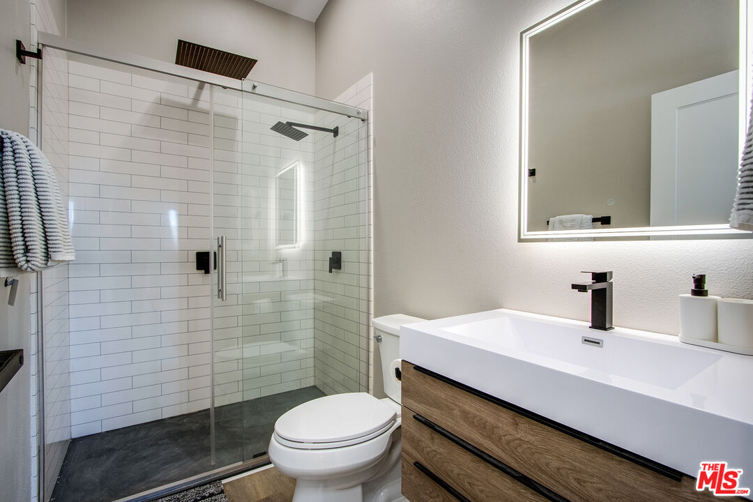 60777 Adele Road Landers, CA 92285 - Photo 21 of 43 a bathroom with a sink toilet and shower