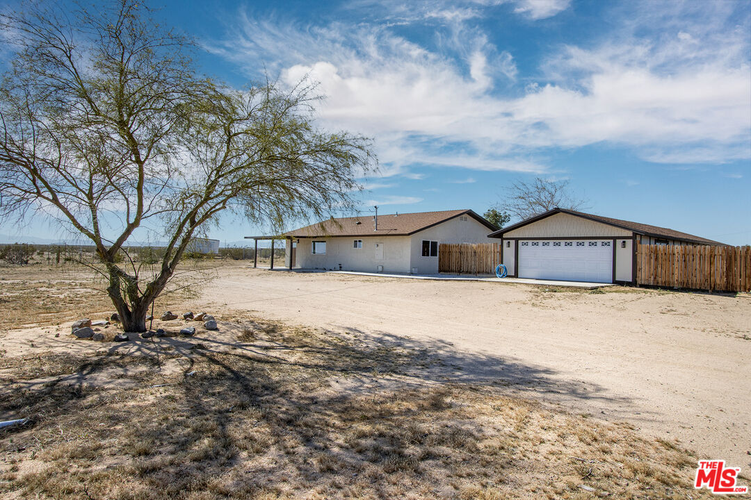 60777 Adele Road Landers, CA 92285 - Photo 26 of 43 a front view of a house with a yard and covered with snow