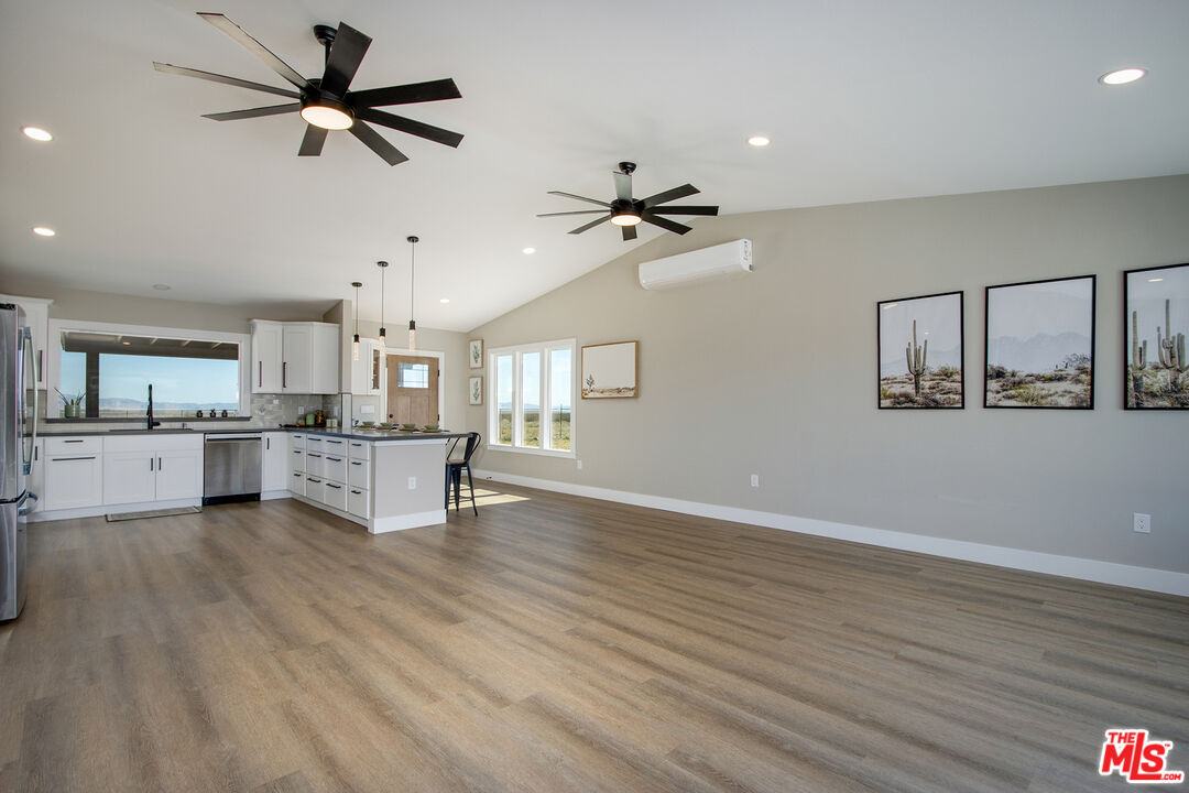 60777 Adele Road Landers, CA 92285 - Photo 9 of 43 a view of kitchen with wooden floor and a ceiling fan