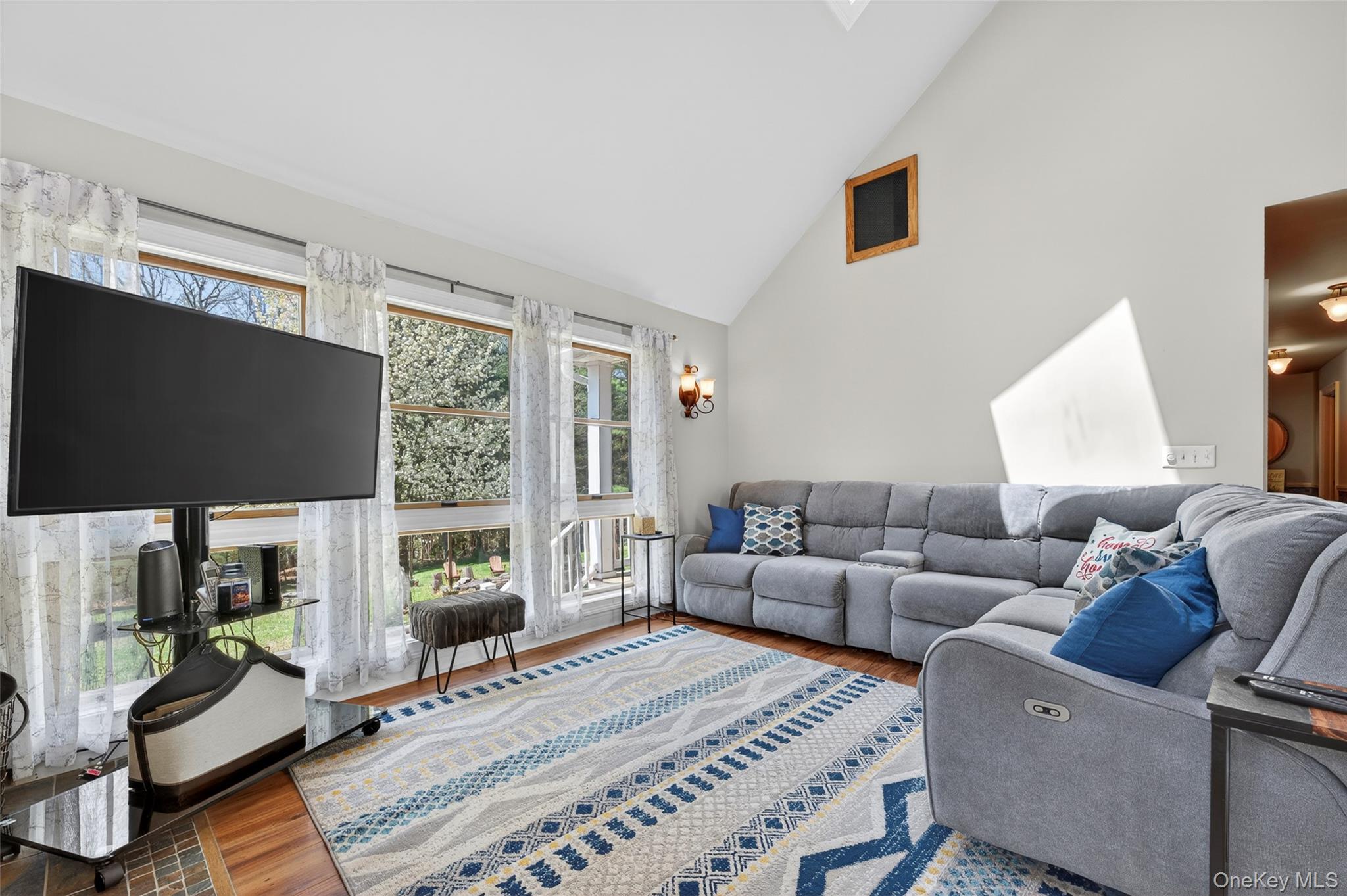 465 Schalck Road Narrowsburg, NY 12764 - Photo 12 of 31 a living room with furniture a rug and a flat screen tv