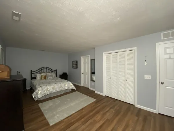 a bedroom with a bed and a night stand