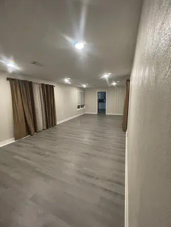 a view of a hallway with a room