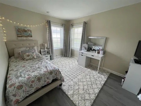 4426 Glasgow Road Burkesville, KY 42717 - Photo 8 of 24 a bedroom with a bed a rug and wooden floor