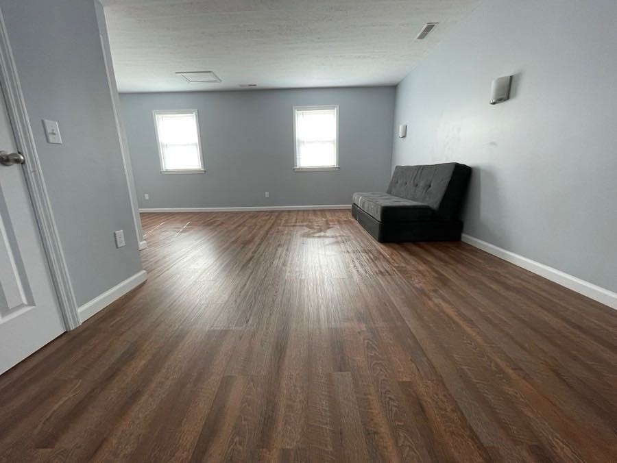4426 Glasgow Road Burkesville, KY 42717 - Photo 10 of 24 an empty room with wooden floor and windows