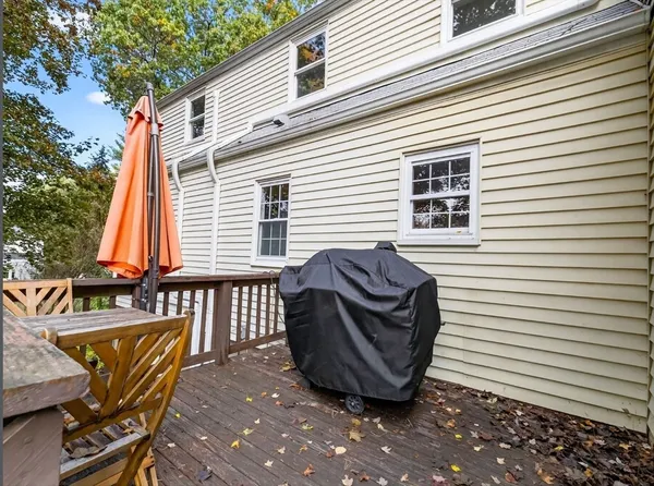 a view of a chair and table in the back yard