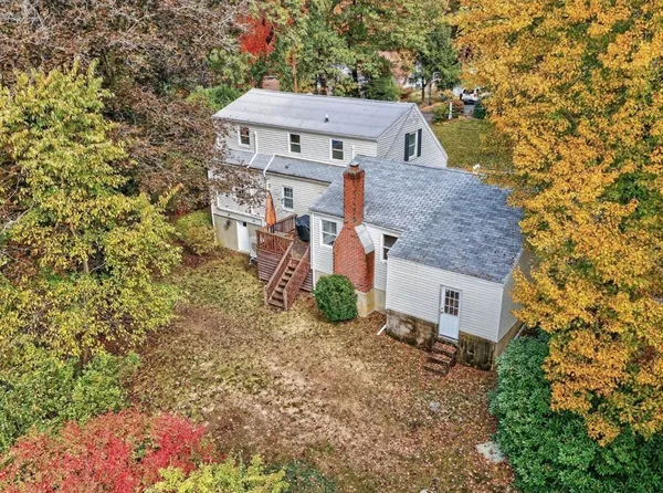 an aerial view of a house with a yard
