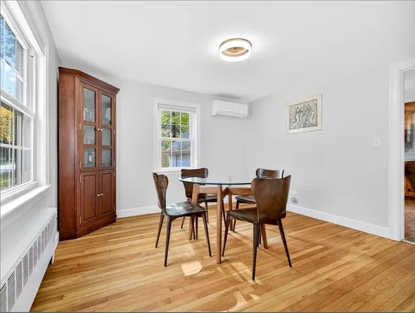 a dining room with furniture and wooden floor
