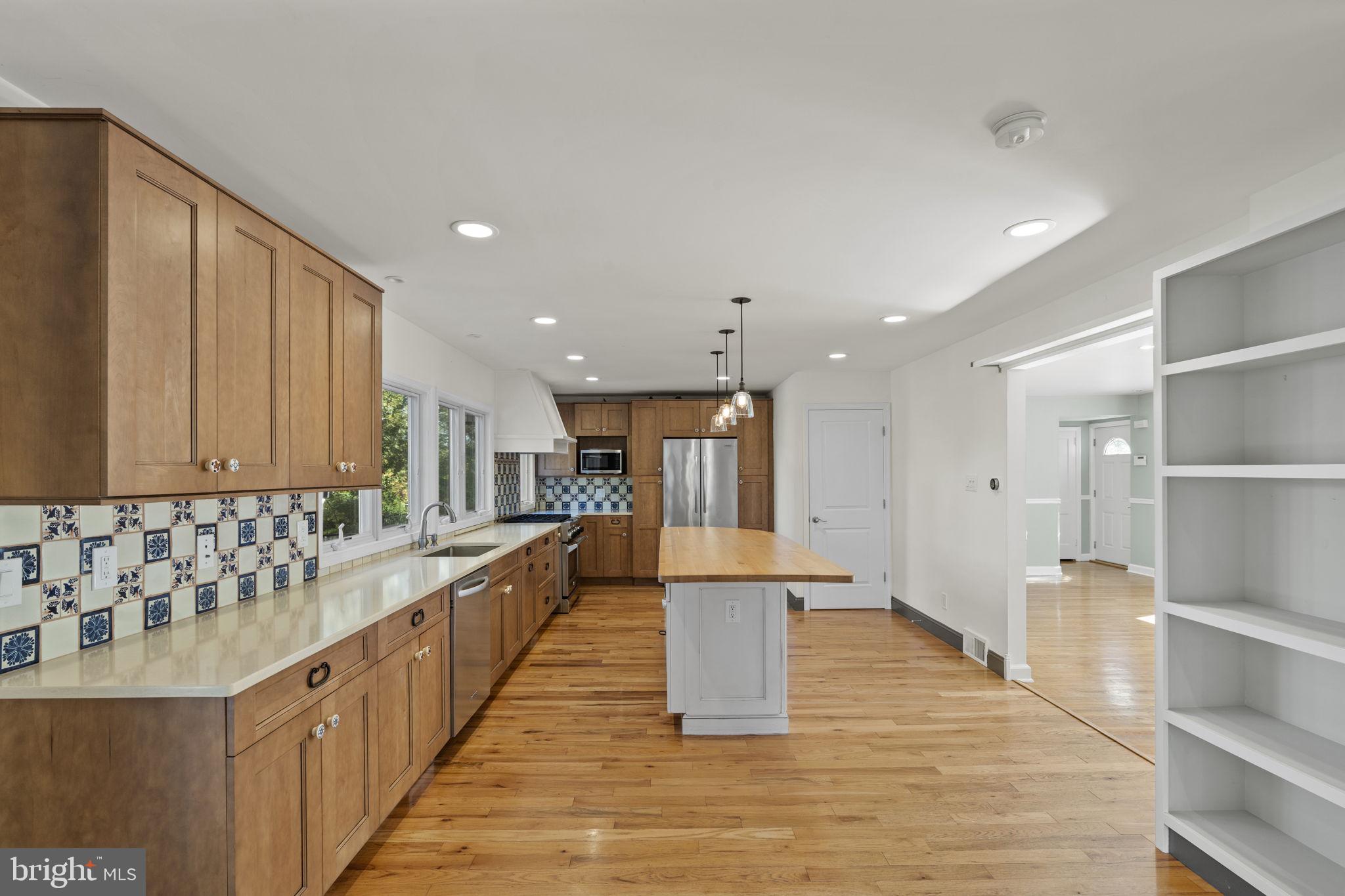 1007 Nicholson Road Wynnewood, PA 19096 - Photo 13 of 29 a large white kitchen with lots of counter space wooden cabinets and stainless steel appliances
