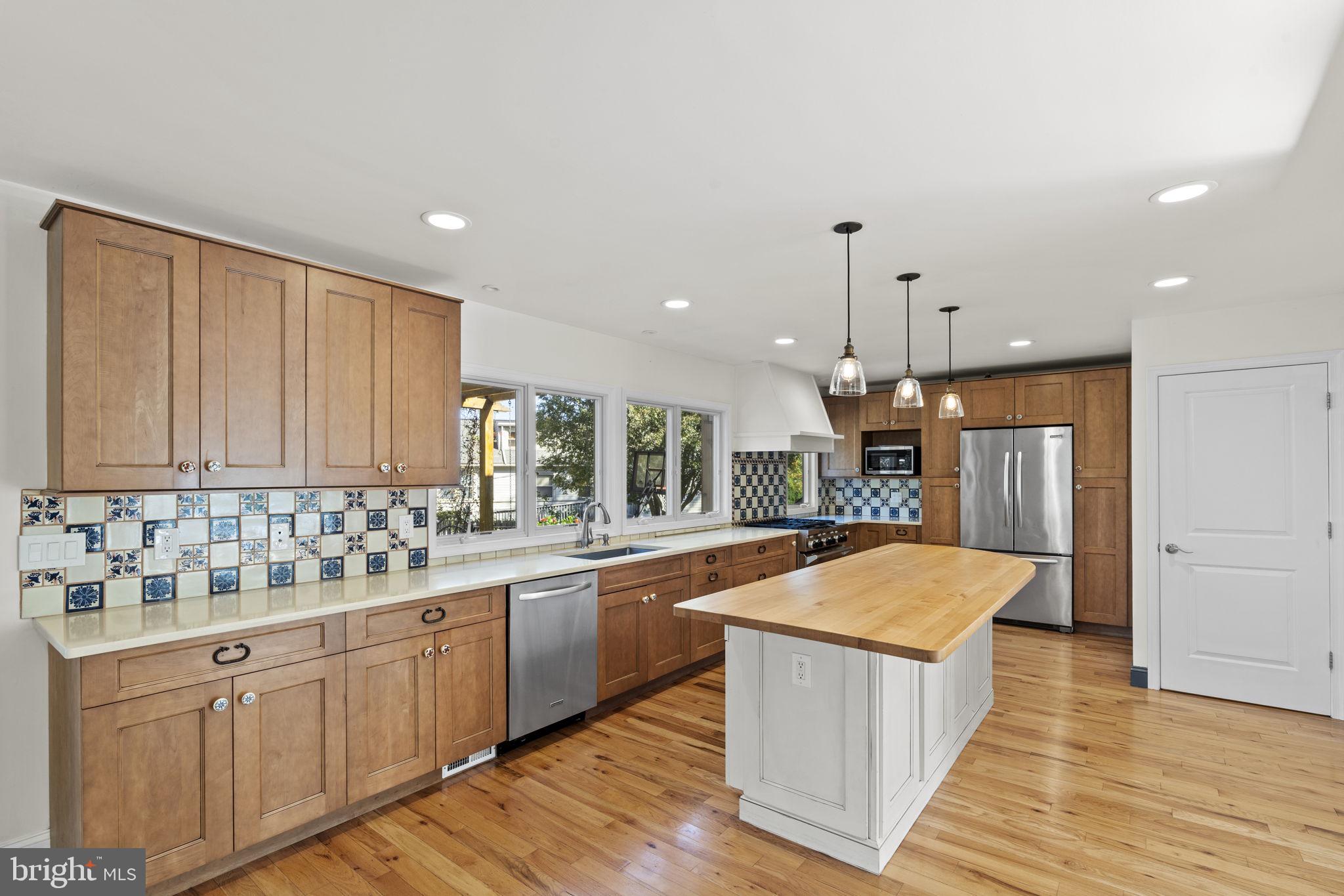 1007 Nicholson Road Wynnewood, PA 19096 - Photo 14 of 29 a large kitchen with kitchen island a sink stainless steel appliances and cabinets