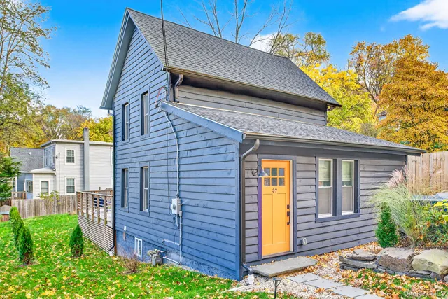 a view of a house with wooden fence