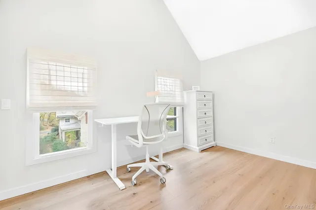 a large white kitchen with cabinets a sink and appliances