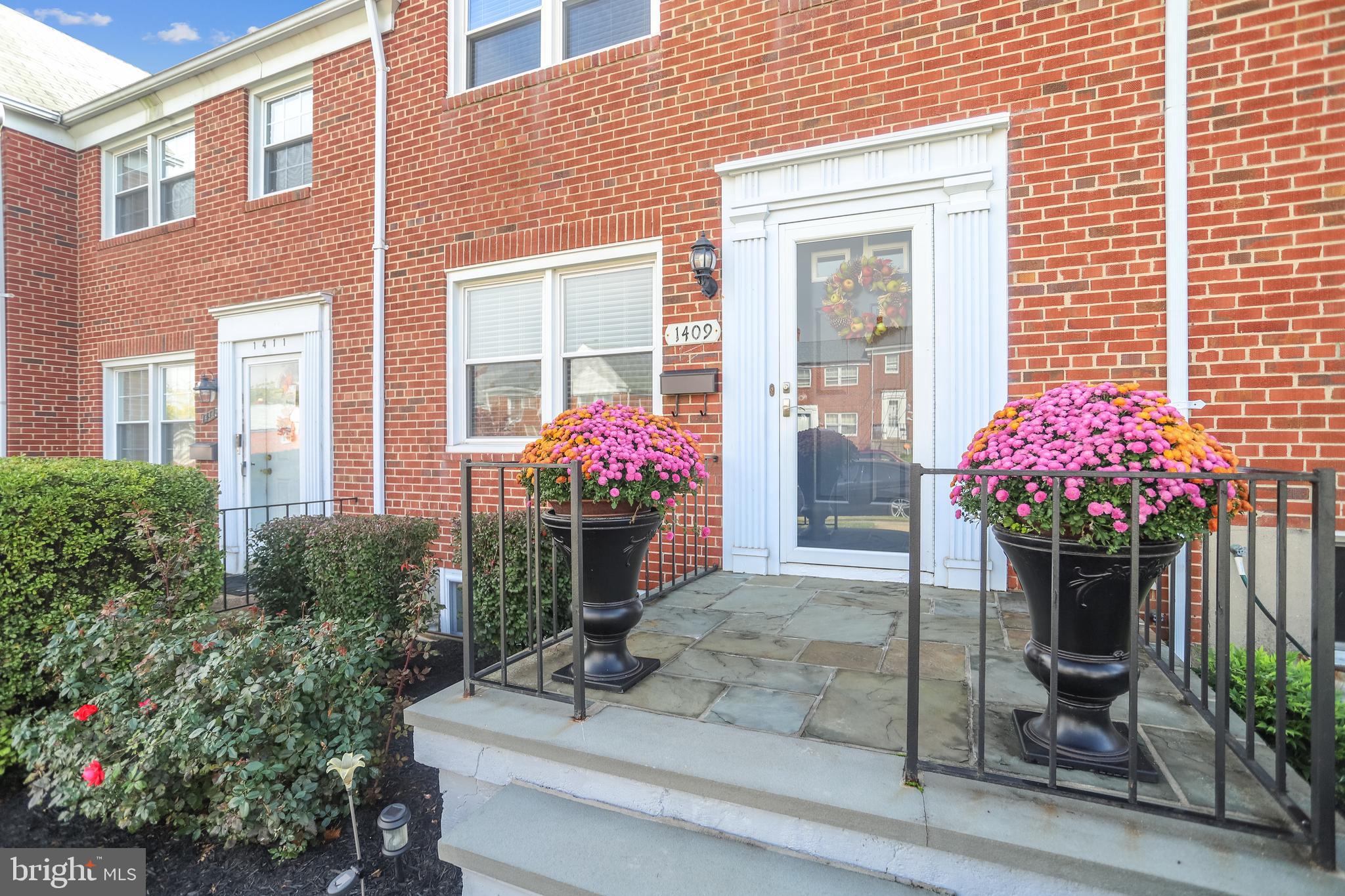 1409 Langford Road Baltimore, MD 21207 - Photo 1 of 39 a front view of a house with a yard