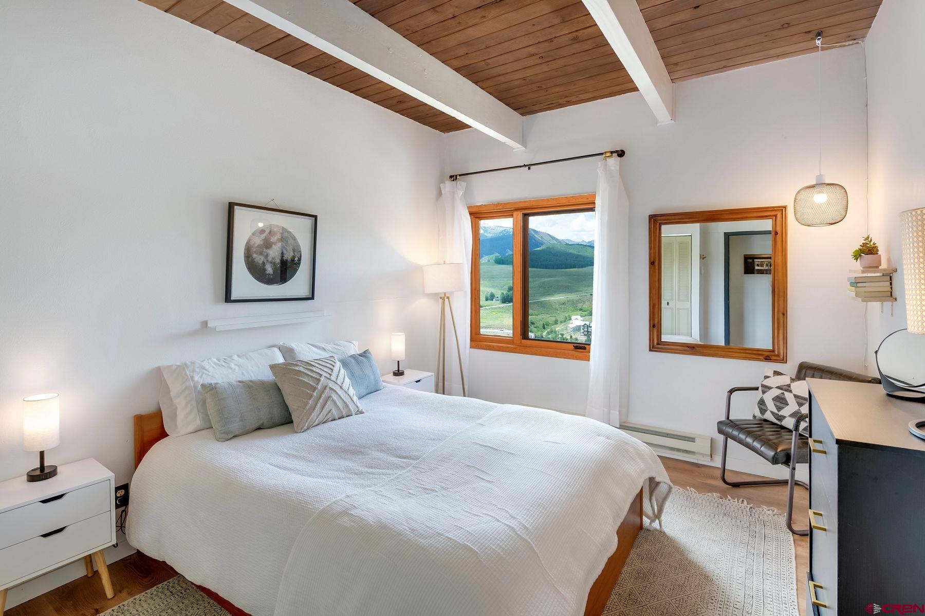 32 Hunter Hill Road, Unit B204 Crested Butte, CO 81225 - Photo 17 of 33 a bedroom with a bed and a window