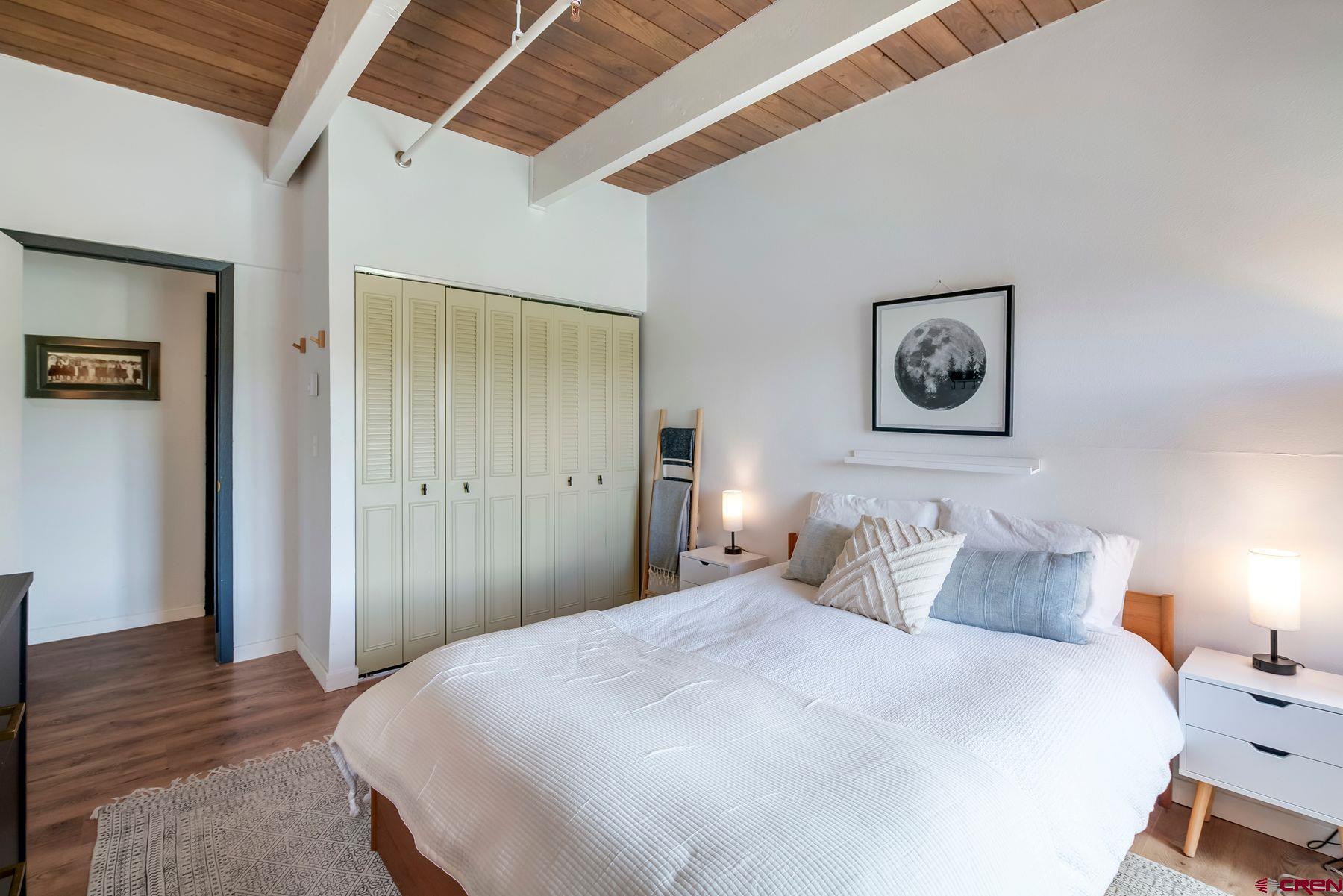 32 Hunter Hill Road, Unit B204 Crested Butte, CO 81225 - Photo 18 of 33 a bedroom with a bed and wooden floor